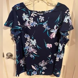 Navy short flutter sleeve blouse with pink flowers.